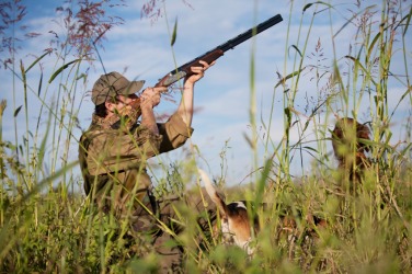 This hunter is using a gun as his weapon. This hunter is using a gun as his weapon.