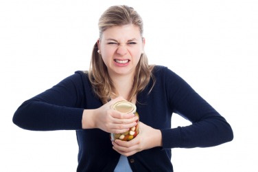 This woman is having to force open a jar. This woman is having to force open a jar.