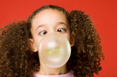 A little girl chewing bubble gum. A little girl chewing bubble gum.