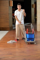 This man is part of a hotel's housekeeping staff. This man is part of a hotel's housekeeping staff.