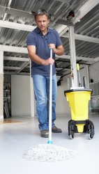 A man uses a mop. A man uses a mop.
