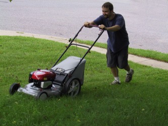 A man mows his yard. A man mows his yard.