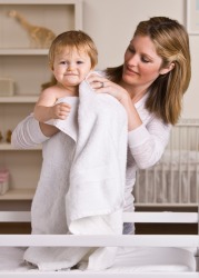A mother drys her baby with a towel. A mother drys her baby with a towel.