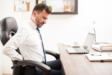An office worker with a pang in his back. An office worker with a pang in his back.