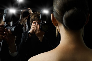 Paparazzi taking photographs of a celebrity. Paparazzi taking photographs of a celebrity.