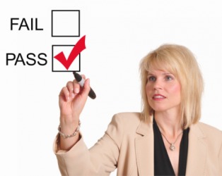 Teacher checking off a passing grade. Teacher checking off a passing grade.