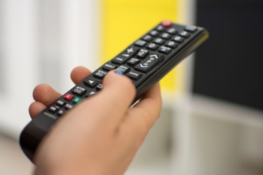 A person pressing the pause button on a remote control. A person pressing the pause button on a remote control.