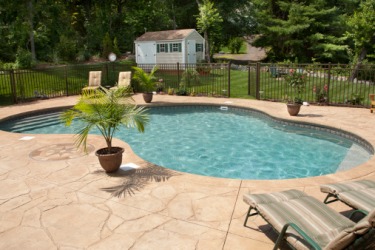 The patio deck forms a periphery around the pool. The patio deck forms a periphery around the pool.