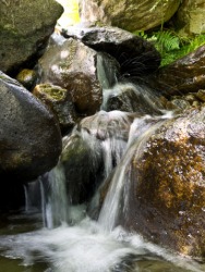 The rocks were made smooth from the physical weathering of moving water. The rocks were made smooth from the physical weathering of moving water.