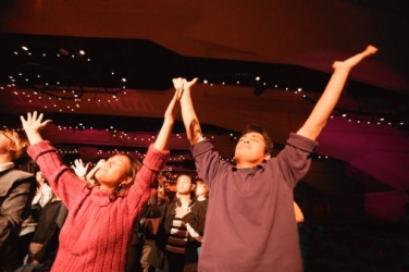 The congregation expressed their piety by opening their arms when the music played. The congregation expressed their piety by opening their arms when the music played.