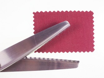 A piece of fabric cut with pinking shears. A piece of fabric cut with pinking shears.