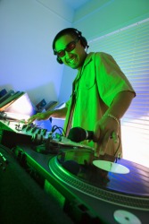 A DJ pivoting a record to make music. A DJ pivoting a record to make music.