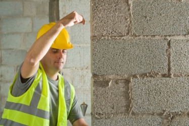 A construction worker using a plumb line. A construction worker using a plumb line.