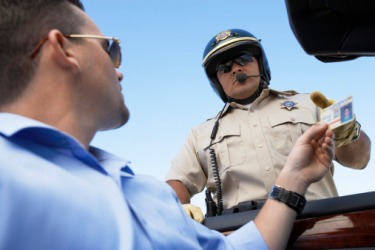 A policeman checking man's identification. A policeman checking man's identification.