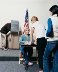 People standing in a line waiting to vote at a polling station People standing in a line waiting to vote at a polling station