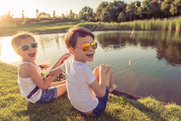 Children fishing in a pond. Children fishing in a pond.