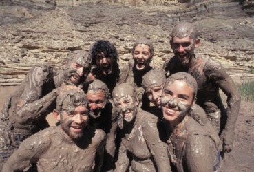 A group of people covered in mud. A group of people covered in mud.
