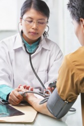 A doctor checking a patients blood pressure. A doctor checking a patients blood pressure.