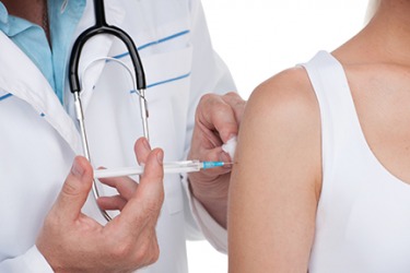 A patient getting a vaccination. A patient getting a vaccination.