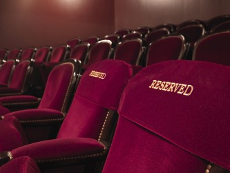 First row of reserved seats in a theater. First row of reserved seats in a theater.