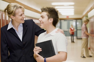 A school principal talking to a student. A school principal talking to a student.