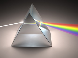 White light passing though a prism creating the full spectrum of colors.