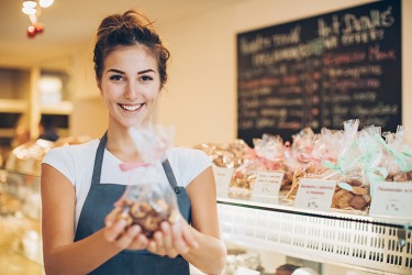 Getting a bag of cookies from the bakery. Getting a bag of cookies from the bakery.