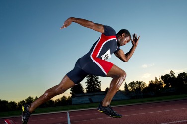 A sprinter practicing at the track. A sprinter practicing at the track.