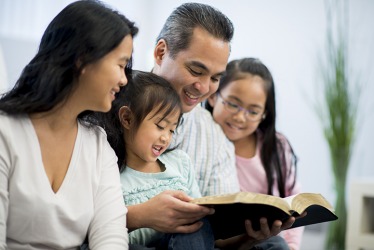 The parents promulgate the lessons in the Bible to their children by reading together. The parents promulgate the lessons in the Bible to their children by reading together.