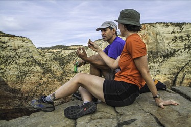 A couple taking a break to snack on the provisions they packed. A couple taking a break to snack on the provisions they packed.