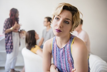 The young woman's psychosocial issues prevented her from enjoying herself at the party. The young woman's psychosocial issues prevented her from enjoying herself at the party.
