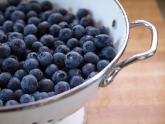 A colander full of blueberries. A colander full of blueberries.