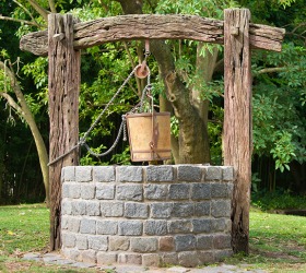 The pulley raises and lowers the well bucket. The pulley raises and lowers the well bucket.