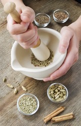 Pulverizing spices into a powder using a mortar and pestle. Pulverizing spices into a powder using a mortar and pestle.