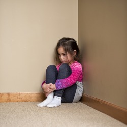 The mom punished her daughter for talking back and made her sit in the corner to think about her actions. The mom punished her daughter for talking back and made her sit in the corner to think about her actions.