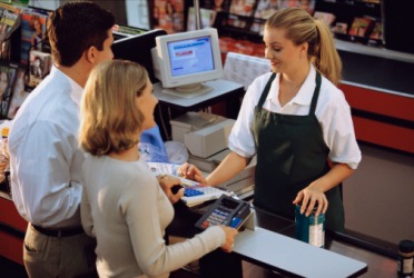 The couple purchase ingredients at the grocery store to make dinner. The couple purchase ingredients at the grocery store to make dinner.