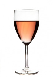 A glass of blush wine. A glass of blush wine.