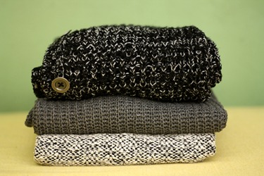 The top and bottom sweaters in the stack are woven in a ragg pattern. The top and bottom sweaters in the stack are woven in a ragg pattern.