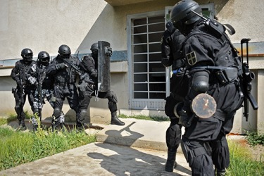 A SWAT raid drill at an abandoned building. A SWAT raid drill at an abandoned building.