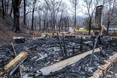 The family's belongings were destroyed when their house was razed by the fire. The family's belongings were destroyed when their house was razed by the fire.