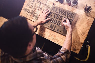 Tim reclaims wood to create one-of-a-kind artistic signs. Tim reclaims wood to create one-of-a-kind artistic signs.
