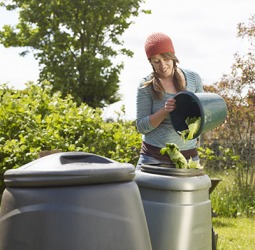 Jade is recycling vegetable scraps by discarding them into the compost bin. Jade is recycling vegetable scraps by discarding them into the compost bin.