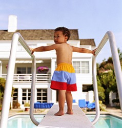 Bradon showed some reluctance as he jumped off the diving board into the pool even though his father was waiting to catch him. Bradon showed some reluctance as he jumped off the diving board into the pool even though his father was waiting to catch him.