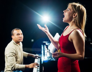 The opera singer's resonant voice is powerful and breathtaking as it fills the theater with sound. The opera singer's resonant voice is powerful and breathtaking as it fills the theater with sound.