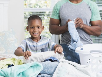 Devon is very helpful around the house and is eager to take responsibility for helping his dad fold the laundry. Devon is very helpful around the house and is eager to take responsibility for helping his dad fold the laundry.