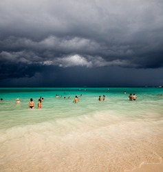 The rumble in the distance from the approaching thunderstorm alerted the beach goers to take cover. The rumble in the distance from the approaching thunderstorm alerted the beach goers to take cover.