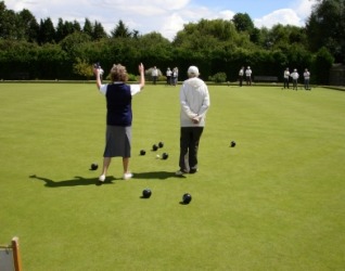 People playing a game of bowls or lawn bowling. People playing a game of bowls or lawn bowling.