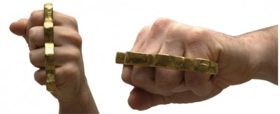 A fist wearing brass knuckles. A fist wearing brass knuckles.