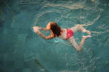 A young woman doing the breast stroke. A young woman doing the breast stroke.