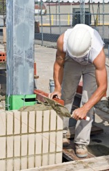 A bricklayer at work. A bricklayer at work.
